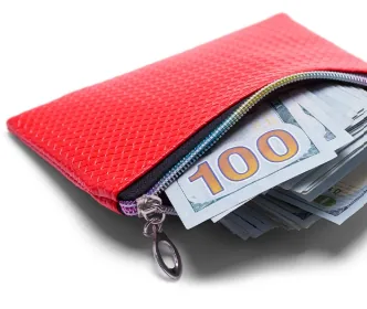 A red purse stuffed with hundred-dollar bills